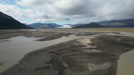 backwards view of glacier river streaming across the valley in south iceland