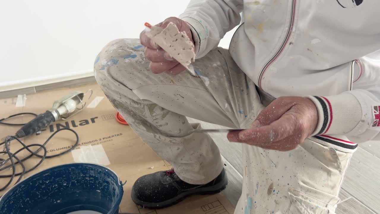 Craftsman is adding sticky painting material, preparation for later adding to walls to fill fine hole surface, repairing and maintaining indoor house concept