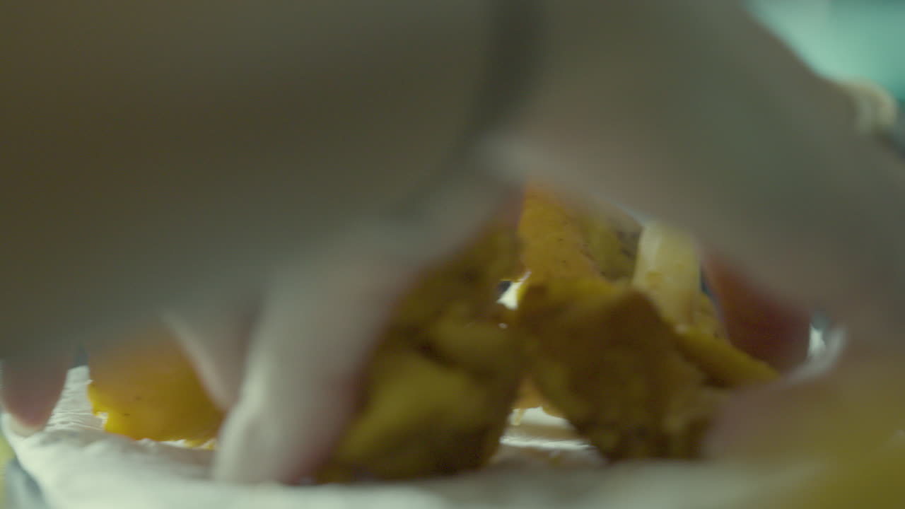 Close-up of hands grasping chanterelle mushrooms in slow motion