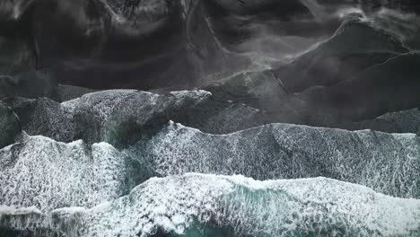 aerial view of dramatic waves crashing against the dark rugged coastline of tjørnuvík, faroe islands, highlighting striking contrasts between white surf and black terrain with vivid natural textures