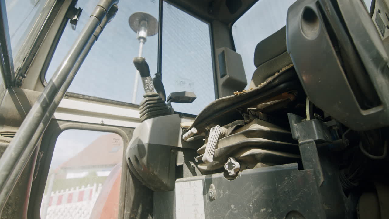 Looking into the operator's cab of a mini excavator