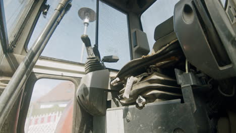 looking into the operator's cab of a mini excavator