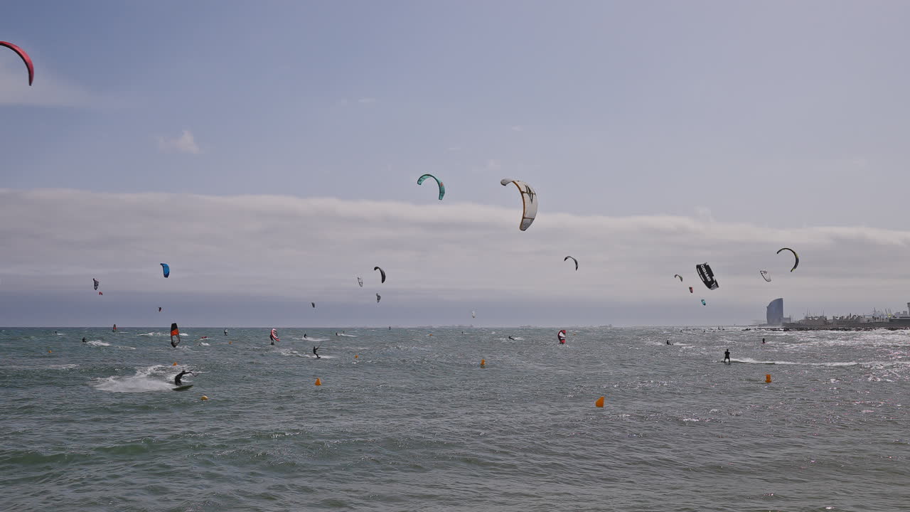 Kitesurfers on a windy day at sea in barcelona