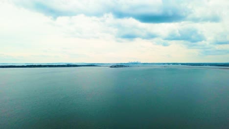 aerial view over calm atlantic ocean with city and islands on the horizon