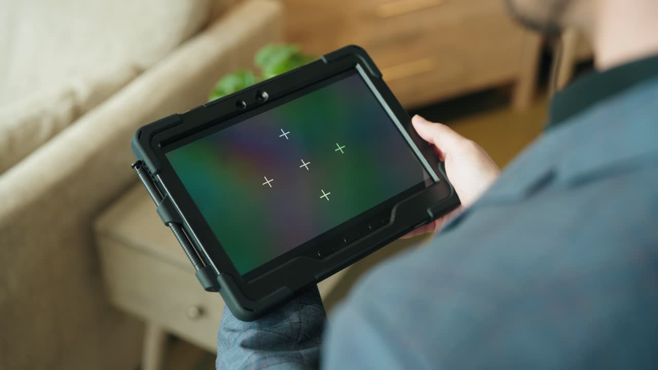 Suit hands lift tracked tablet in static over-shoulder retail shot