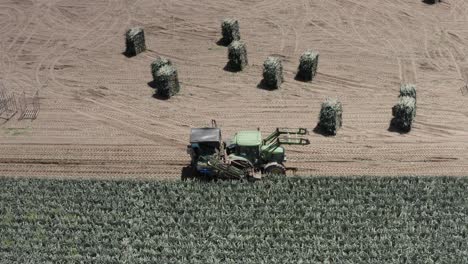 agricultural tractor harvesting in a field