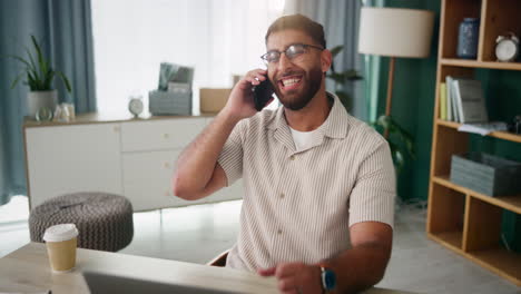 a man talking on the phone in his home office