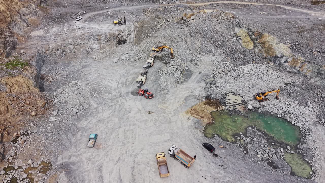 Aerial View of Heavy Machinery Working in a Large Stone Quarry