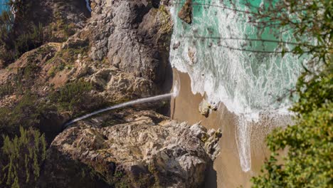 vertical shot of mcway falls on the coast of big sur, california, usa