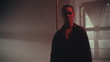 woman in leather jacket in a dark studio