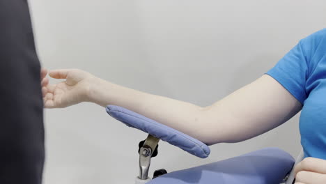 Capture of a nurse putting a bandage on a woman&#039;s arm after drawing blood for testing