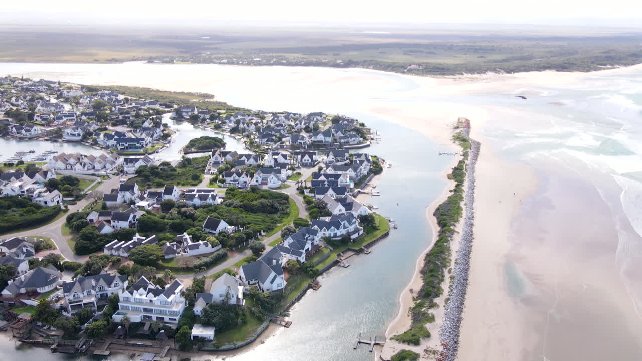 Breakwater and Krom River mouth with St. Francis Bay canal-side homes, aerial