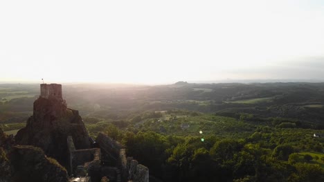 trosky castle at bohemian paradise during a golden hour with balloons in the distance, fly nearby, 4k or uhd, 30fps