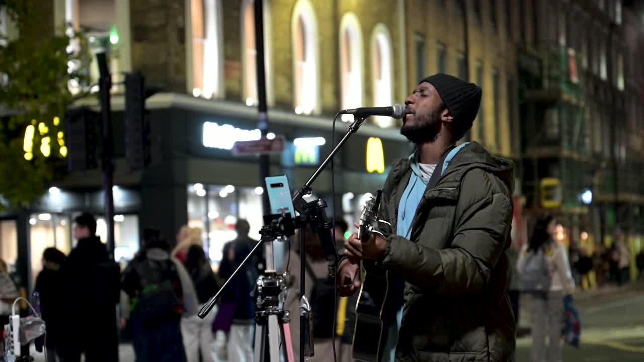 Artist performing outside of Kings Cross Station, Kings Cross, London, United Kingdom