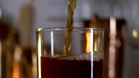 bubbly soda pouring in to rocks glass in slow motion