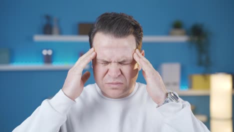 man with headache is suffering and he doesn't like it at all. migraine pain.