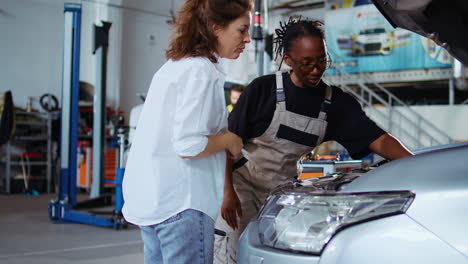 technician in garage fixes customers car