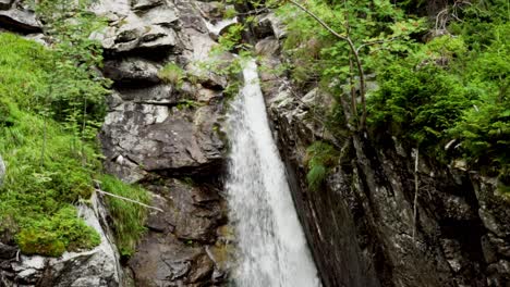 river running downstream and forming beautiful waterfall in between the rocks, untouched nature