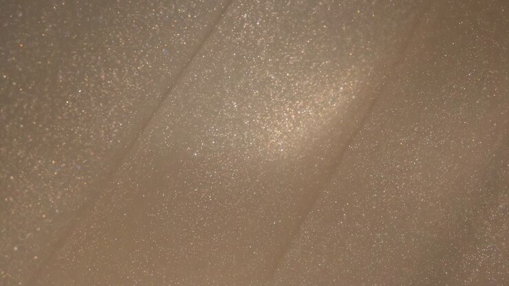 Shimmering skin patch reflecting brightening vanity light in macro shot, with glitter particles