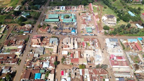 Aerial-view-of-cars-and-people-at-a-Open-Air-Market,-in-Africa---reverse,-drone-shot