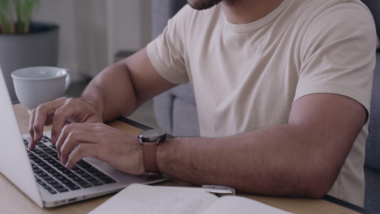 Male student typing an online assignment