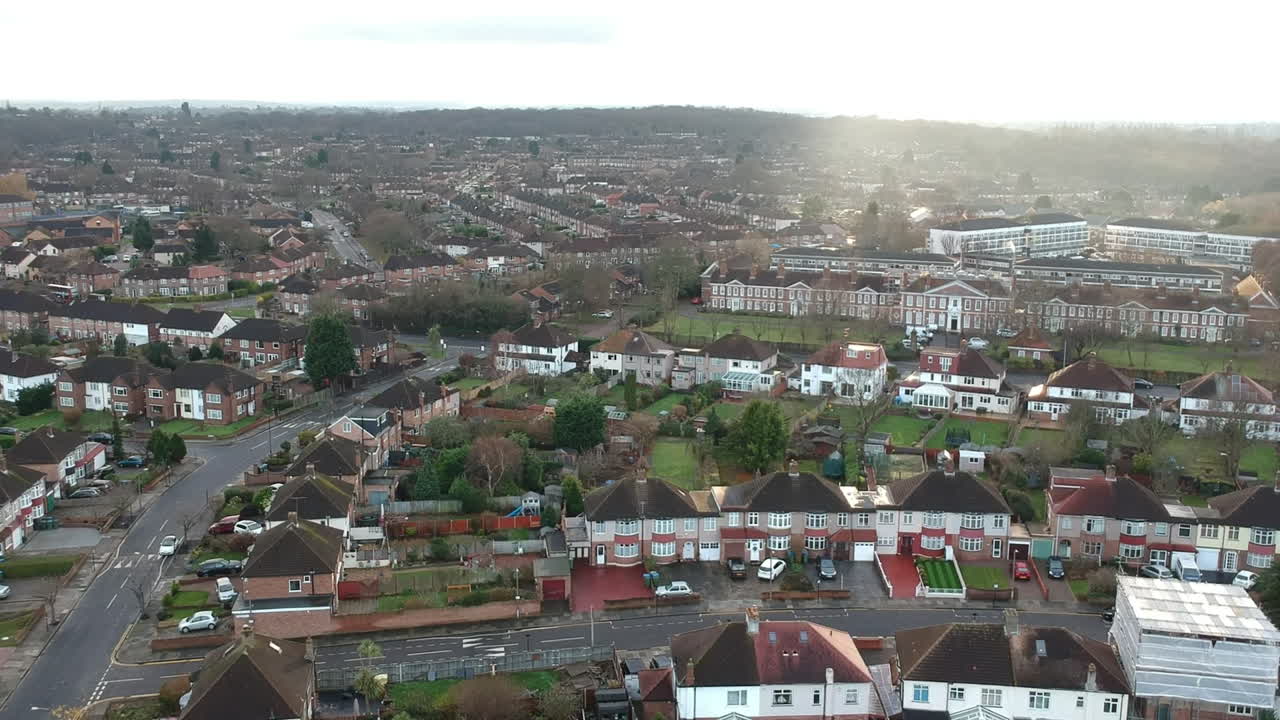 Drone View of Mottingham Suburbs in South East London: Quiet Neighborhood with Brown Tiled Terrace Houses and Well-Maintained Back Gardens