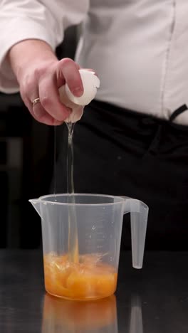 chef separating eggs for baking