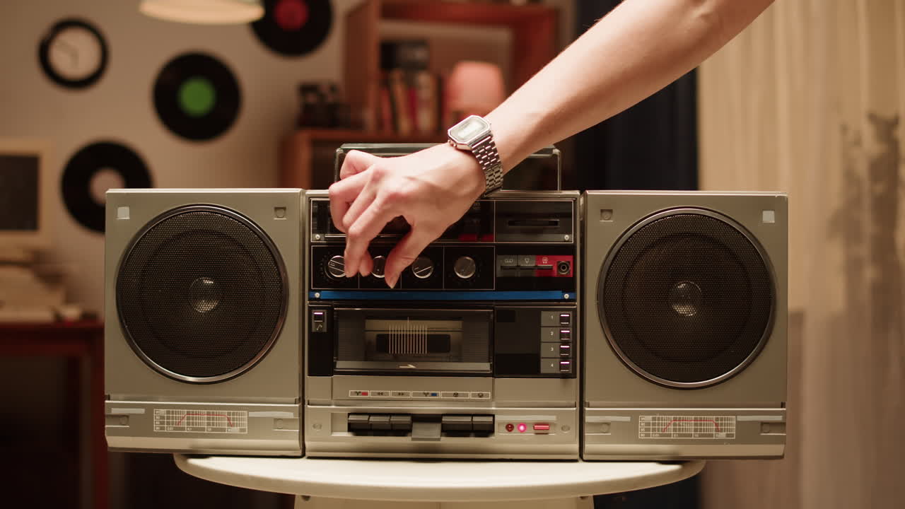 Person Adjusting a Vintage Boombox