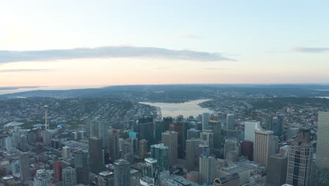 wide aerial shot high above seattle's downtown sector at sunset with lake union in the distance