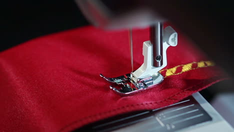 sewing needle stitching seam on fabric in slow motion . sewing machine in action