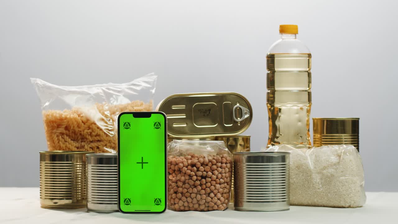 Canned cereals beans fish and vegetables, an assortment of processed foods, supermarket cart online shopping, delivery.