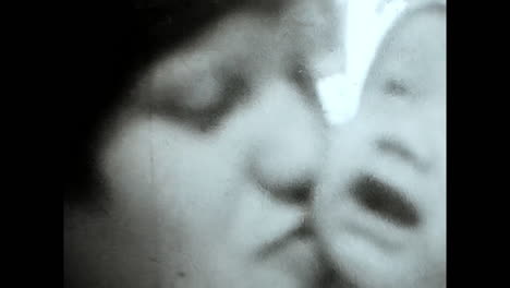 soviet woman holding baby in arms, a heartwarming moment from the ussr archives. circa ussr 1980s: a touching video from the soviet unions archives captures a woman tenderly cradling a baby in his arms.