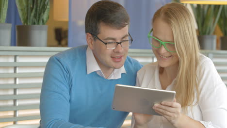 Man-and-woman-spending-time-with-tablet-PC-in-cafe