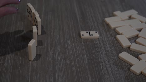 senior citizen female hand places a domino in the game