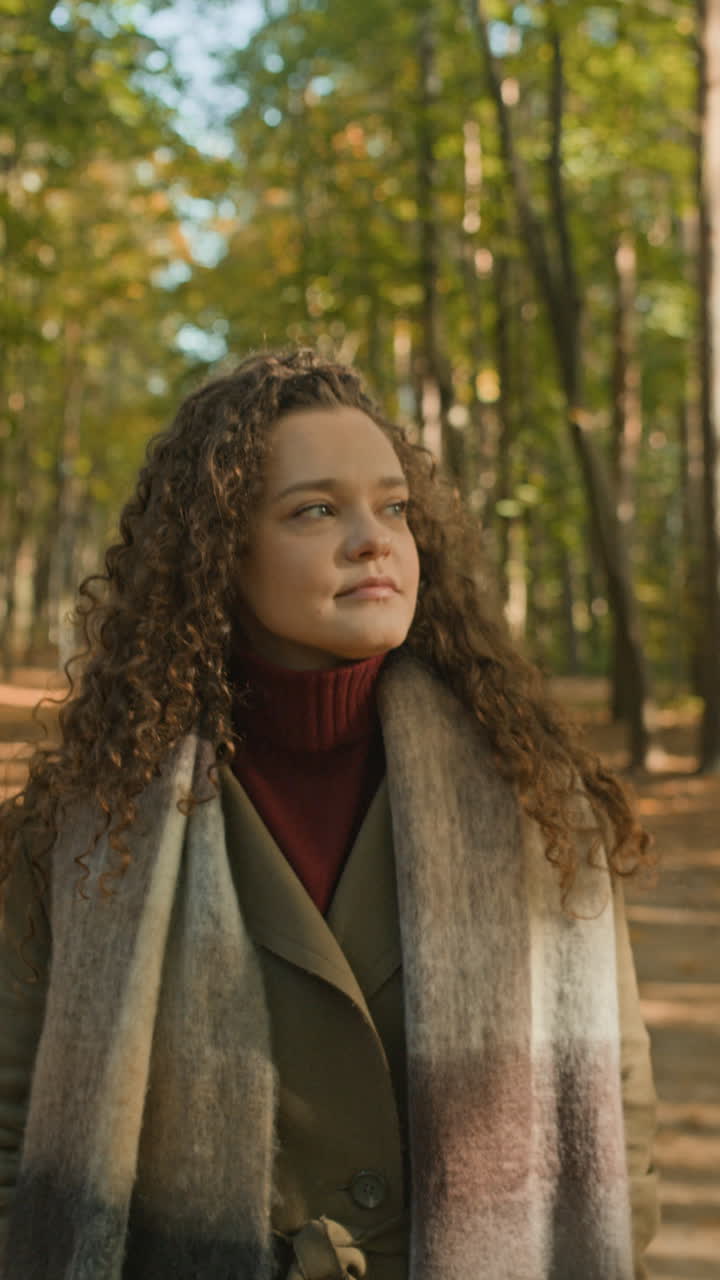 Woman with curly hair in autumn forest