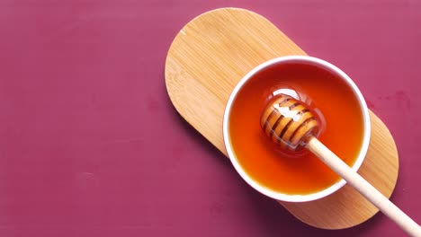 honey in a bowl with wooden dipper