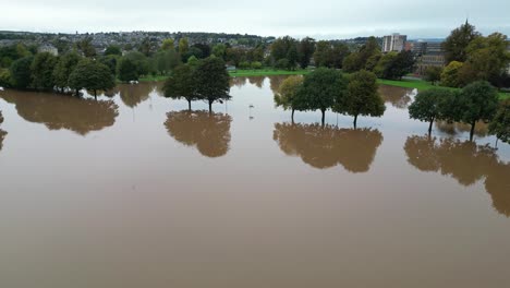 aerial revealing shot of flooded south inch park in perth and kinross