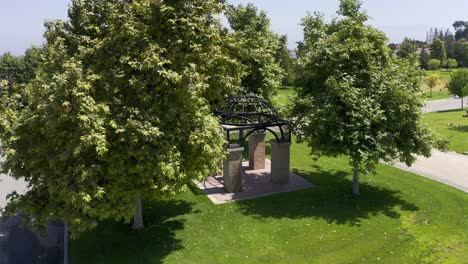 Aerial-close-up-descending-shot-of-a-decorative-gazebo-at-a-California-mortuary