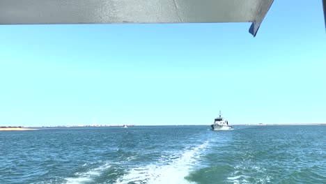 a patrol ship patrolling near a cargo seaport at daytime