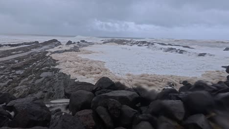 powerful waves breaking onto rocks at snapper rocks in gold coast, queensland. cyclone alfred hits australia. panning shot