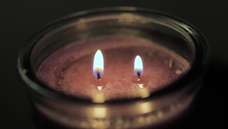 candle with two wicks being lit two fires one candle