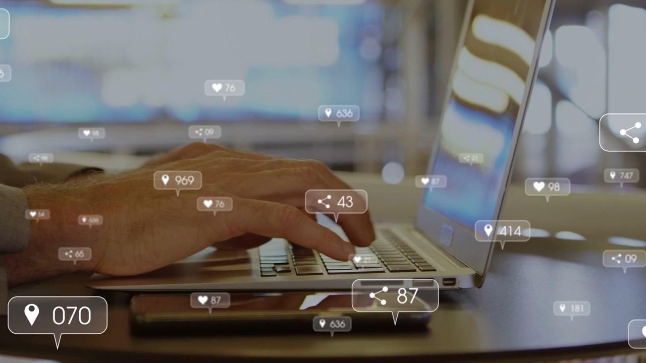 Man typing on laptop, first press starting social media likes growing around phone and hands