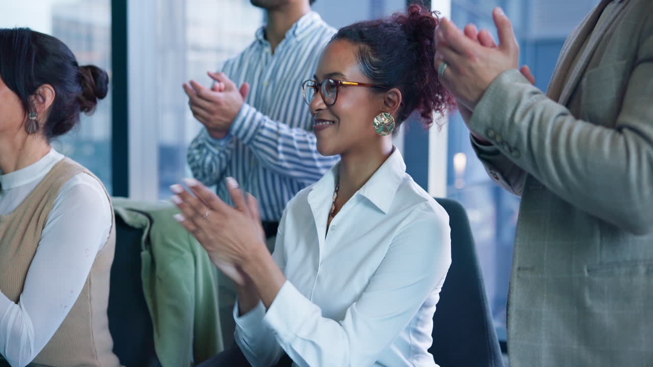Business professionals applauding in an office