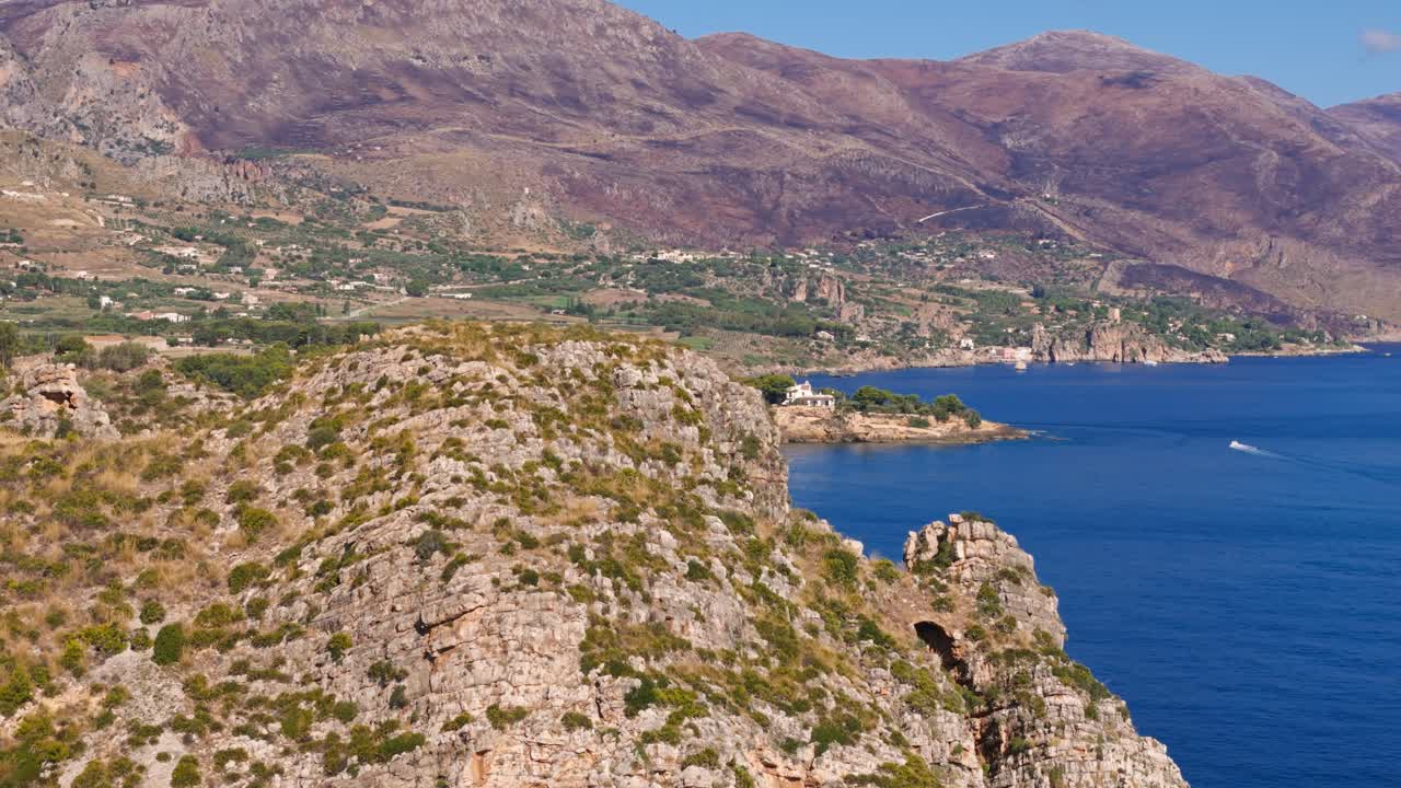 Scenic coastline of Cala Rossa, Sicily; rugged cliffs and blue sea