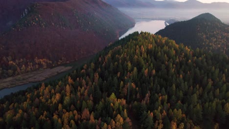 A-hill-next-to-rivere,-autumn-drone-aerial