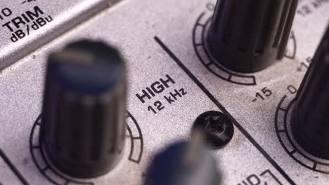 increasing high frequency sound on analog mixing console, macro close up