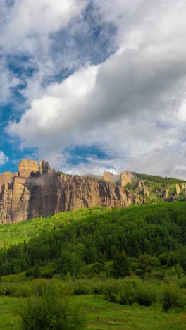 Vertical Timelapse, Clouds Above Mill Castle Rock Formations on Sunny Summer Day, Crested Butte, Colorado USA