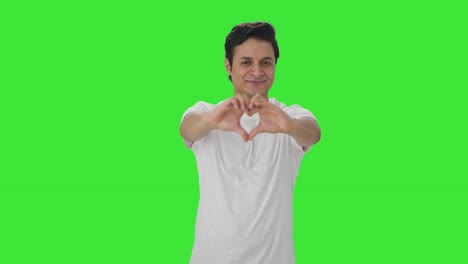 happy indian man showing heart sign green screen