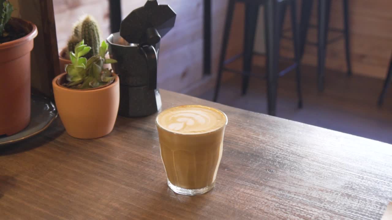 Serving Glass Of Latte At The Counter In A Coffee Shop. close up, slow motion