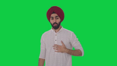 sick sikh indian man having an asthma attack green screen